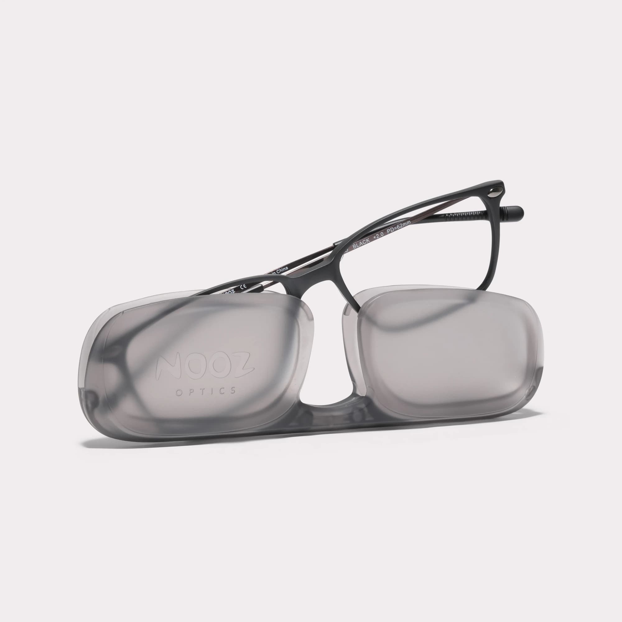 A pair of Bao Black Multi-distance™ reading glasses coming out of its case